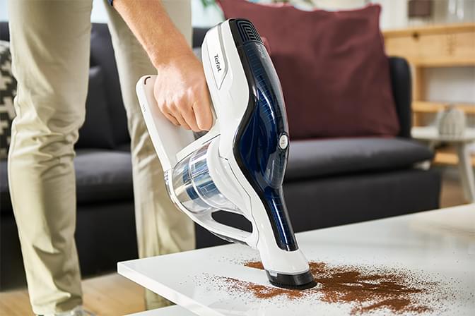 Man vacuuming on a table